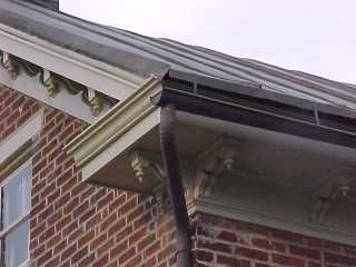 Downspout also coated with bronze acrylic applied by Roof Menders