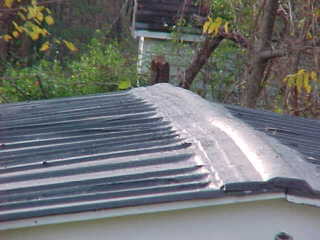 Crew of Roof Menders used flashing along panel horizontal seams and ridge