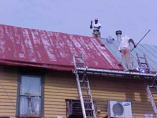 Base work in red going over gey primed area by Roof Menders crew