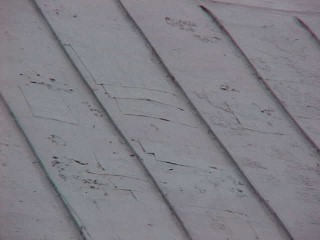 Roof Menders crew performed repairs on weak areas of paneling before priming