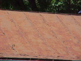 Roofing panels before application of sealer for tin roofs